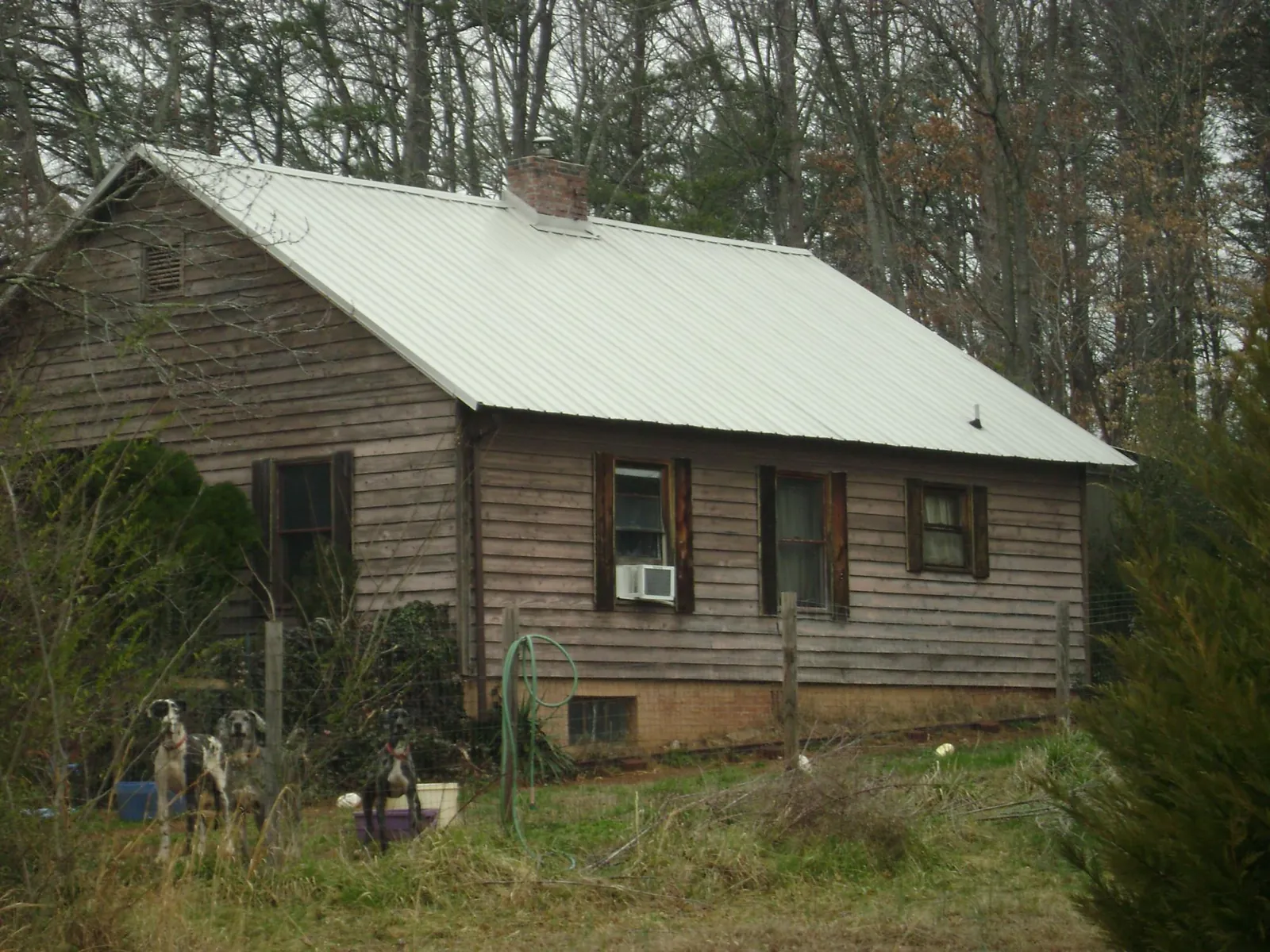White metal roof on an old wood sided farmhouse, from a Asphalt Shingle Roof Repair job in Brooklyn